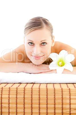 Close-up of a radiant woman lying on a massage table with a flow