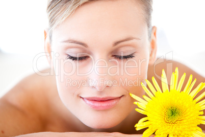 Close-up of a relaxed woman lying on a massage table with a flow