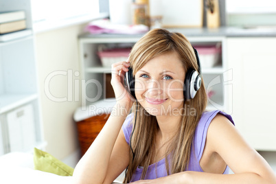 Joyful caucasian woman listening to music with headphones in the