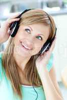 Delighted caucasian woman listening to music with headphones in