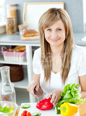 Close-up of a woman cutting paprika in the kitchen