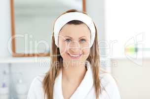 Charming young woman smiling at the camera in the bathroom