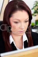 Self-confident businesswoman working at her desk