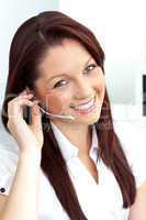 Charming young businesswoman wearing headphones smiling at the c