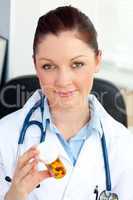 Close-up of a concentrated female doctor holding pills