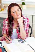 Pensive young girl studying at home