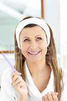 Pretty woman filling her nails in the bathroom