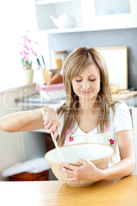 Portrait of a cute woman cooking a cake in the kitchen