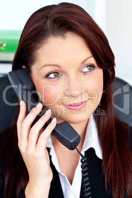 Pretty businesswoman talking on phone sitting