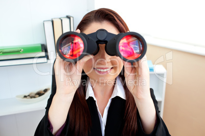 Radiant businesswoman sitting on a chair and looking through bin