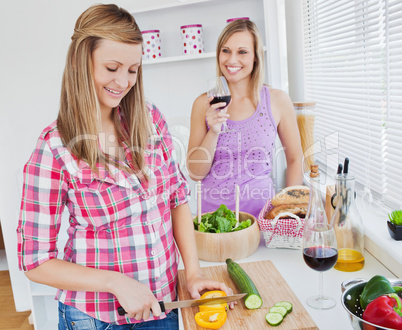 Two positive women cooking together at home