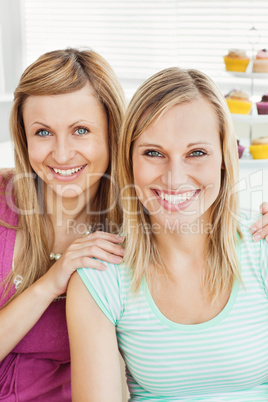 Smiling caucasian friends drinking coffee in the kitchen