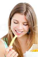 Happy young woman eating fries