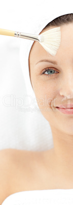 Close-up of a happy young woman enjoying a beauty treatment