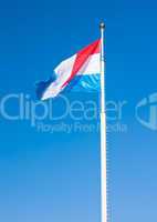 Flag of Luxembourg over blue sky