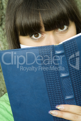 Female in a park with a notebook