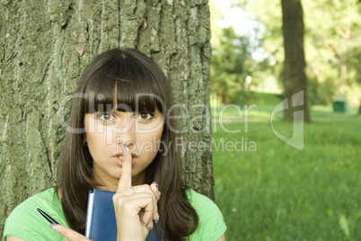 Female in a park with a notebook