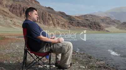 Man relaxing at mountain lake