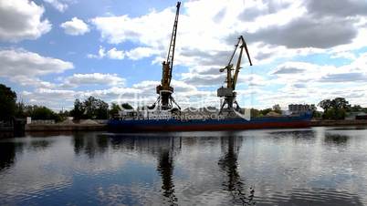 shipboard cranes and sailing boat