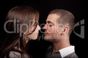 Woman and man posing on a black background