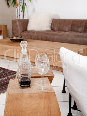 Champagne glasses with modern couch in background
