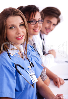 Doctors in hospital gowns in row