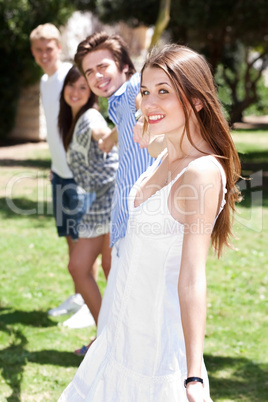 Four teens hang out in a park