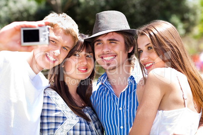 Friends taking self portrait, outdoors