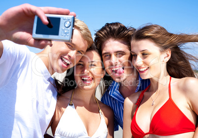 Friends taking self portrait, outdoors