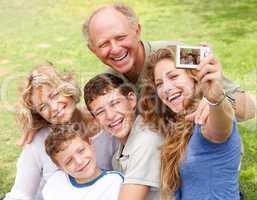 Family outdoors taking self portrait