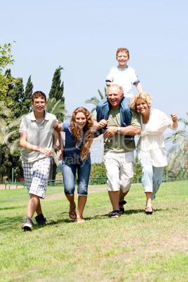 Happy family playing in the park