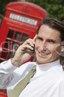 Businessman On Cell Phone In London With Red Telephone Box