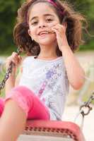Lovely girl on a swing in the park