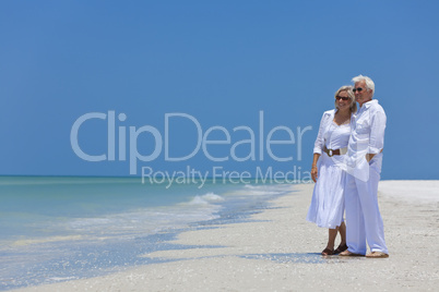 Happy Senior Couple Looking To Sea on A Tropical Beach