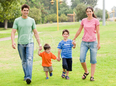 Happy family walking in the park