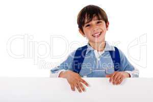 Boy standing behind the blank board
