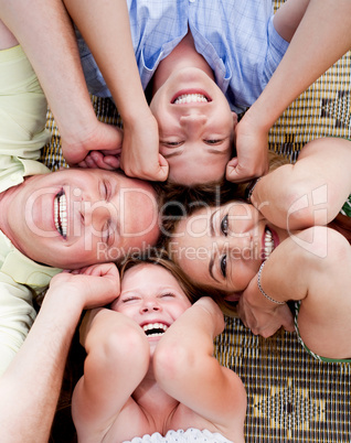 Happy family lying in a circle