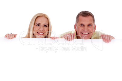 Man and woman holding empty white board