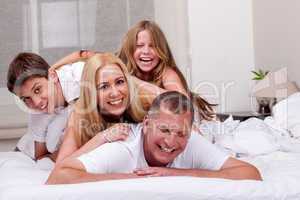 Family having fun in bed