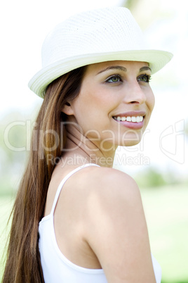 Happy young woman in hat looking away