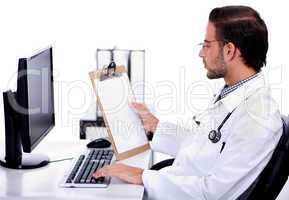 Young ethnic doctor looking at medical report deeply