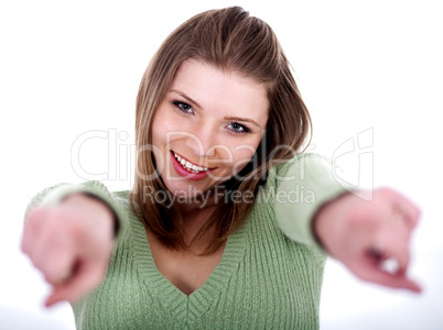 Smiling young female pointing through her both hands