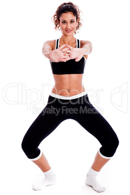 Cute fitness girl stretching her hands