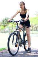 Young fitness woman on bicycle