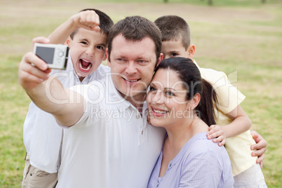 Happy family pilled together and taking self portrait