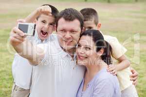 Happy family pilled together and taking self portrait