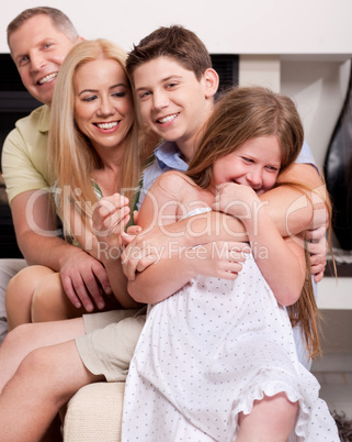 Happy family sitting in straight and having fun
