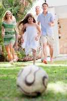 Happy family playing soccer and having fun