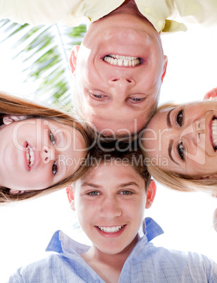 Happy family smiling and joining their heads together