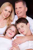 Portrait of happy family posing towards the camera